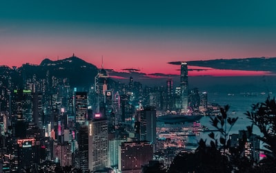 An image depicting a bustling Hong Kong skyline at night, with neon-lit online gambling platforms prominently displayed